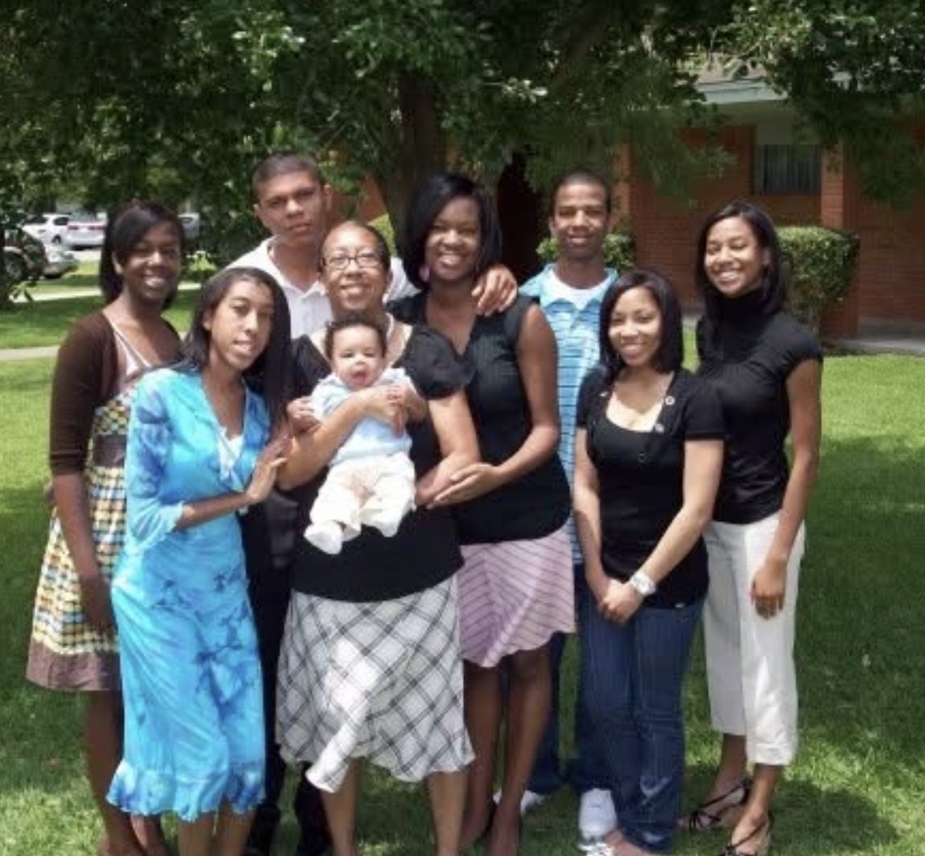 Knighton family gathering outside under the trees