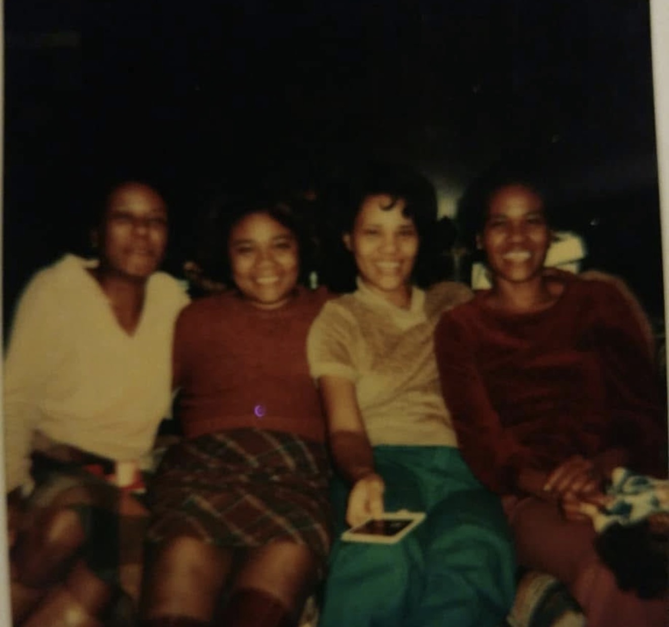 Four Knighton women smiling together at a gathering
