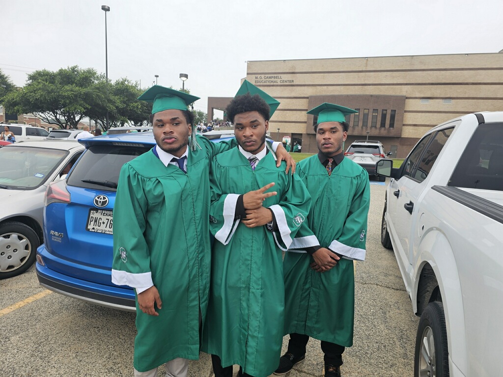 Three Knighton graduates in green caps and gowns